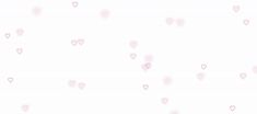 pink hearts are flying in the air on a white background that is very blurry