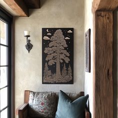 a living room filled with furniture and a painting hanging on the wall next to a window