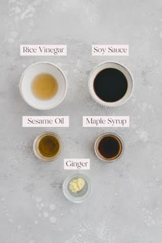 four different types of sauces in small bowls on a gray surface with labels describing them