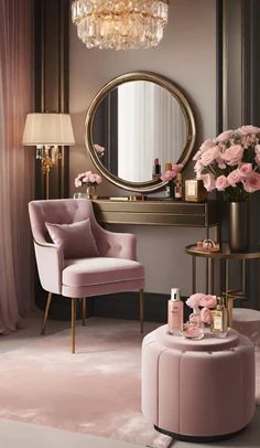 a pink chair sitting next to a table with flowers on it and a round mirror