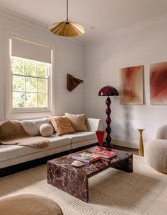 a living room filled with furniture and a lamp