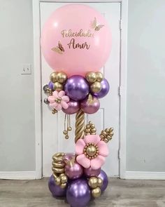 a bunch of balloons that are in the shape of flowers and butterflies on top of each other