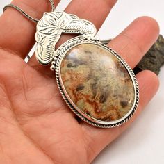 "Crazy lace agate necklace sterling silver large oval lace agate pendant orange brown beige antique bohemian style, artisan boho jewelry A beautiful large oval crazy lace agate stone with hues of brown, beige and orange in sterling silver statement pendant. Lovely autumn colors and winter colors too. The stone is set inside a bezel and framed with braided wire . On top of it there is an engraved antique floral pattern. I have oxidized it to bring out the details and achieved this bohemian look T Bohemian Jewelry With Oval Pendant Natural Stones, Silver Oval Bohemian Necklaces, Antique Brown Agate Jewelry, Bohemian Silver Necklace With Large Stone, Bohemian Oval Agate Necklace, Handmade Brown Oval Necklace, Beige Bohemian Jewelry, Bohemian Agate Jewelry With Large Pendant, Artisan Brown Necklace With Oval Pendant