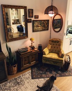 a living room filled with furniture and pictures on the wall