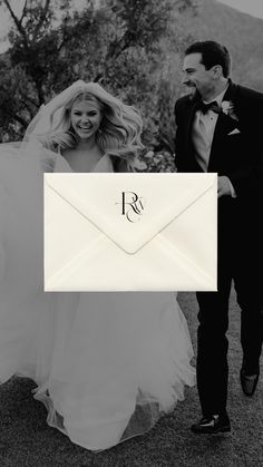 a bride and groom walking towards an envelope