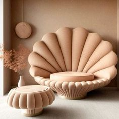 an unusual shell shaped chair and table in a room