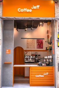 an orange coffee shop with the door open