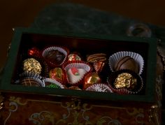 a box filled with assorted chocolates on top of a table