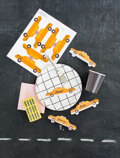 a black table topped with yellow and white paper cut outs next to construction themed items