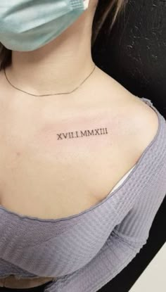 a woman wearing a face mask and tattoos on her chest, with the words ximx written