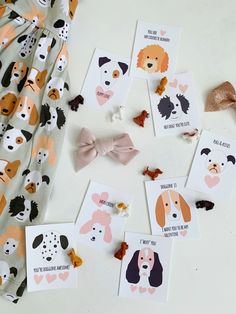 several different dogs and their names are on the table next to some cards with bows