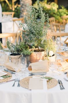 the table is set with silverware and place settings for an outdoor dinner party or celebration