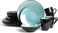 a stack of black and blue dishes with cups