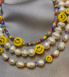 This beaded pearl necklace is perfect for brightening up any outfit! Dress it up for a more elegant night out, or wear it casually for a chic, beachy look. Perfect for the summer months or a touch of fun during an overcast winter day. This necklace is made out of freshwater pearls and 10mm yellow happy face beads, finished with silver hardware. Necklace Length: 14.5 inches - We add a 2in extender chain at the end to make the necklace adjustable (14.5 inches - 16.5 inches) - If you would like a d Yellow Beaded Pearl Necklace, Yellow Pearl Beaded Necklaces As Gift, Trendy White Beaded Necklaces For Party, Trendy Pearl Necklace With Colorful Beads, Party Beaded Necklaces With Letter And Round Beads, Party Letter Beaded Necklaces, Trendy Pearl Necklace With Letter Beads, Trendy Pearl Necklace With Round Beads, Trendy Beaded Pearl Necklaces