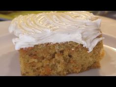 a piece of carrot cake with white frosting on a plate