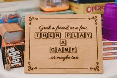 a wooden sign that says grab a friend or a few then play a game at maybe fun