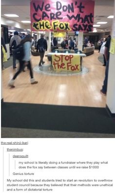 a group of people walking through an office lobby with signs on the walls and in front of them