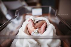 a newborn baby is wrapped in a blanket