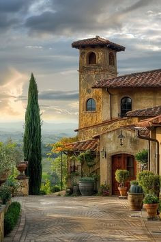 an old style house with a clock tower in the middle of it's courtyard