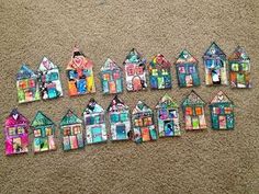 a group of small colorful houses sitting on top of a carpet