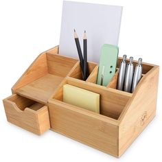 a wooden desk organizer with pens, pencils and notes in the bottom compartment on a white background