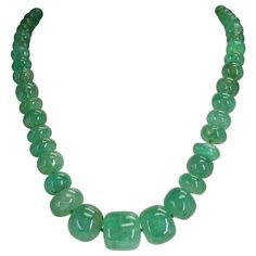 A magnificent Genuine & Natural Large Emerald Tumbled Beads Necklace with a Pearl Clasp. The beads range from 9MM to 22MM and the length is 22.5." The total weight is 820 carats: the clasp is 310 carats and the Emeralds weigh 790 carats. We can also customize the necklace according to your preferences, as per the number of strands, the size of the beads, the weight, etc. Please contact us for more information. Luxury Green Pearl Chain Necklace, Luxury Polished Beads Emerald Necklace, Luxury Green Jewelry With Spacer Beads, Luxury Beaded Emerald Necklaces, Luxury Jade Beaded Necklace With Gemstone Beads, Luxury Green Single Strand Beaded Necklace, Necklaces Beaded, Glamorous Jewelry, Gold Link Necklace