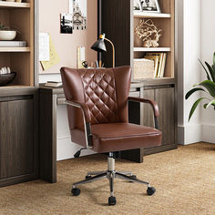 a brown leather office chair sitting in front of a book shelf with books on it