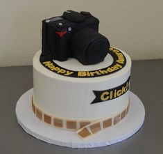 a birthday cake with a camera on top