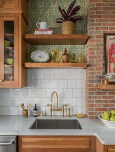 a kitchen with wooden cabinets and marble counter tops, white tile backsplash and open shelving above the sink