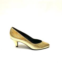 Vintage 1980s metallic gold disco party pumps by Life Stride. Features gold lamé textured uppers, rounded pointy toe, black insoles, and short cone heel. Excellent vintage condition with some minor scuffs, like new sole. Heel to toe (inside shoe): 9.25 inches Ball of foot (bottom of sole): 3 inches Heel height: 2.5 inches Size 6 Gold Almond Toe Heels With Sculpted Heel, Gold Court Shoes With Padded Heel For Evening, Gold Fitted Court Shoes With Low Heel, Gold Almond Toe Court Shoes For Formal Occasions, Gold Pointed Toe Court Shoes For Evening, Gold High Heel Court Shoes With Sculpted Heel, Gold Court Shoes With Sculpted Heel, Gold Almond Toe Court Shoes With Padded Heel, Gold Formal Court Shoes With Padded Heel