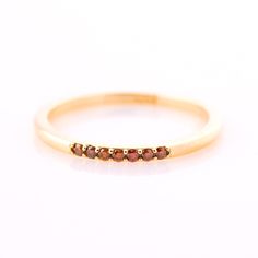 Cognac diamonds ring, made in 14k or 18k yellow gold and set with 7 clear cognac diamonds. The ring surface is elegant and rounded shape while the sides are straight and comfortable for more stackable rings to wear. This listing is for YELLOW GOLD. you can order other colors from the following links: ● Rose gold - https://www.etsy.com/il-en/listing/265477 ● White gold - https://www.etsy.com/il-en/listing/265478002 ♦ DIAMOND SPECIFICATIONS ♦ Pieces: 7 Carat Weight: 0.08 Color: Fancy brown diamond Dainty Diamond Band, Champagne Diamond Rings, Brown Diamonds, Cognac Diamonds, Dainty Band, Stack Ring, Textured Ring, Diamonds Ring, Brown Diamond