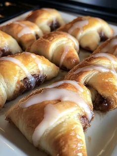 several pastries with icing on a white plate