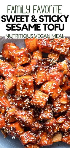 Cubed tofu coated in a sticky sesame sauce, garnished with white sesame seeds, displayed in a bowl, ideal for a nutritious vegan meal.