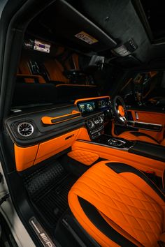 the interior of an orange sports car