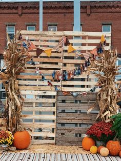 an outdoor display with corn stalks and pumpkins