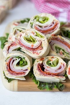 there are many sandwiches on the cutting board