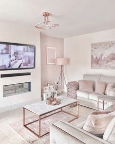 a living room filled with furniture and a flat screen tv mounted on the wall above a fireplace