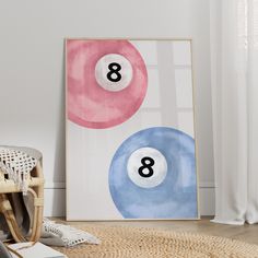 an art print with three pool balls on it in front of a chair and rug