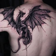 a man with a dragon tattoo on his back