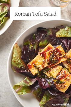 korean tofu salad with sesame seeds and greens in a white bowl on a table