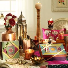 a table topped with lots of different types of decorative items and candles on top of it