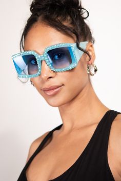 The Azura Sparkly Rhinestone Crystal Rectangle Sunglasses are a stylish and chic accessory to elevate any outfit. The sunglasses feature rectangular frames with rhinestone crystals embedded on the outer edges, adding a touch of glam. The frames are made of durable and lightweight material, ensuring comfort and longevity. The lenses provide 100% UV protection, shielding your eyes from harmful rays. The sunglasses come with a protective case to prevent scratches and damage while on-the-go. Perfect Rectangular Glass Sunglasses For Parties, Rectangular Tinted Sunglasses For Parties, Elegant Rectangular Sunglasses For Party, Elegant Rectangular Party Sunglasses, Rectangular Glass Sunglasses For Party, Trendy Rectangular Party Sunglasses, Trendy Square Sunglasses For Party, Chic Square Sunglasses For Party, Rimless Rectangle Sunglasses