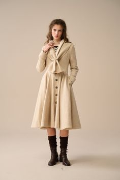 Understated luxury at its finest. Make sure you get the best of the best when it comes to wardrobe staples. this classic and versatile wool coat is everything you need for your next ultra-sophisticated look. The elegant design and timeless look of this coat is reinterpreted in a contemporary way with clean lines and a tailored cut.  Crafted from Premium Wool, the unique texture and grain is as striking as a work of art. Vintage yet sophisticated. Designed with an integrated scarf, drape it over your shoulders for a cozy yet chic look, or wrap it around your neck for added warmth on chilly days. With its generous dimensions, this scarf offers endless styling possibilities, making it a versatile addition to your wardrobe. Undoubtedly your new favourite. 【Fabric】 Outer: 100% Wool Lining:  100 Classic Tailored Knee-length Outerwear, Elegant Beige Knee-length Outerwear, Elegant Knee-length Beige Outerwear, Tailored Beige Wool Coat With Buttons, Vintage Beige Outerwear For Office, Elegant Beige Outerwear With Covered Buttons, Beige Vintage Outerwear For Office, Vintage Wool Coat For Work, Vintage Fitted Wool Coat Single Breasted