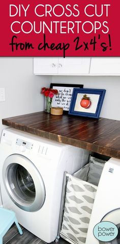 a white washer sitting next to a dryer on top of a wooden counter