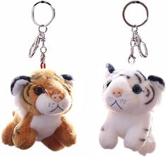 two stuffed animals are hanging from key chains on white background, one is brown and the other is white