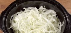 onions are being cooked in the slow cooker