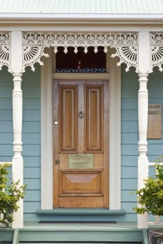 the front door of a blue house with white trim