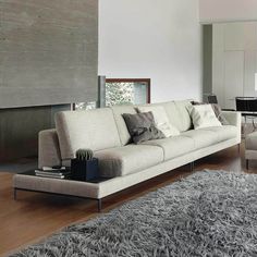 a living room filled with furniture and a large window covered in shades of greys