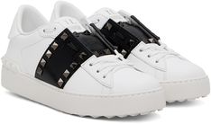 Low-top buffed calfskin and grained patent calfskin sneakers in white and black. · Lace-up closure · Logo patch at padded tongue · Padded collar · Studs at sides and heel counter · Buffed leather lining · Treaded rubber sole Supplier color: White/Black Designer White Patent Leather Sneakers, Luxury White Sneakers With Spikes, Luxury White Spiked Sneakers, White Slip-on Sneakers With Studded Outsoles, Luxury White Studded Sneakers, Valentino One Stud Shoes, Black Lace, Valentino Garavani, Patch Logo