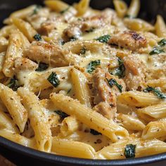 pasta with meat and spinach in a skillet